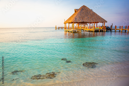 Tropical paradise  Cancun beach with rustic palapa pier  Riviera Maya