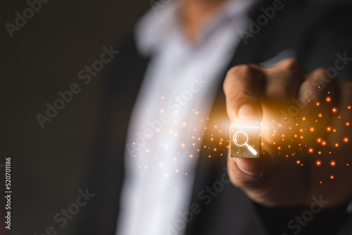 A businessman catching wood box with search icon symbol and computer graphic light, internet and searching technology, browser and data concept shoot with copy space for text and design