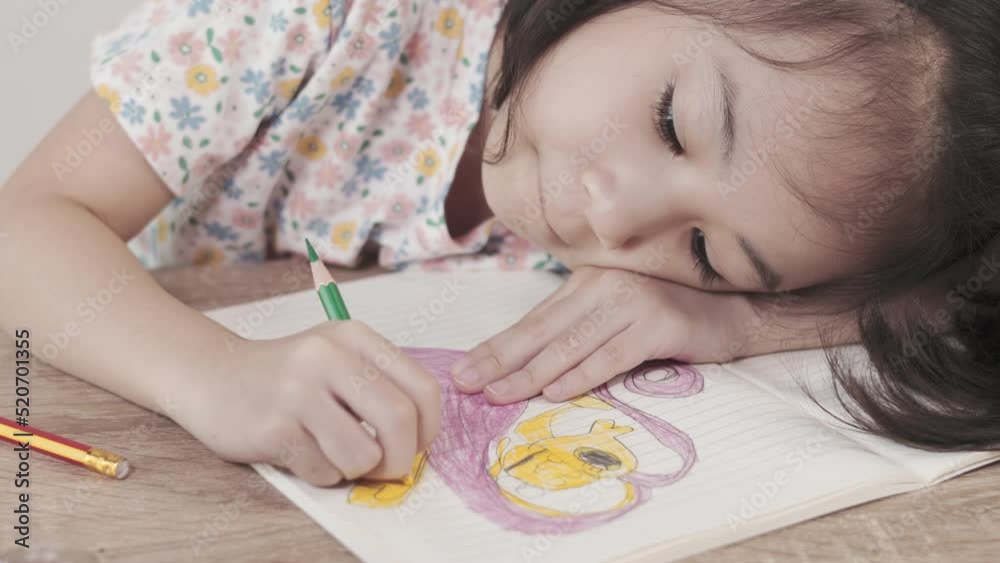Adorable asian girl is doing her homework and sleep on the table with a lot of books. It shows concept of stress, boring and exhausting moment of child learning by herself to gain knowledge. Adorable asian girl is doing her homework and sleep on the table with a lot of books. It shows concept of stress, boring and exhausting moment of child learning by herself to gain knowledge.