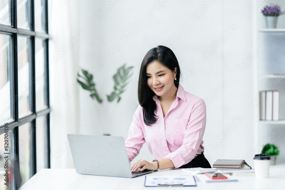 Asian woman working with laptop in her office. business financial concept. Asian woman working with laptop in her office. business financial concept.