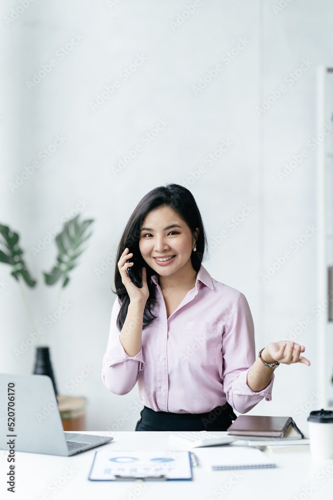 Asian businesswoman in formal suit in office happy and cheerful during using smartphone and working. Asian businesswoman in formal suit in office happy and cheerful during using smartphone and working.