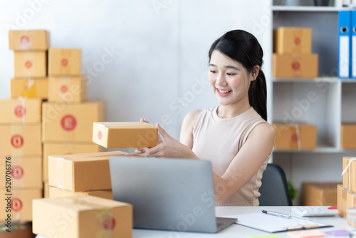 Starting small businesses SME owners female entrepreneurs check online orders to prepare to pack the boxes, sell to customers, sme business ideas online. © PaeGAG