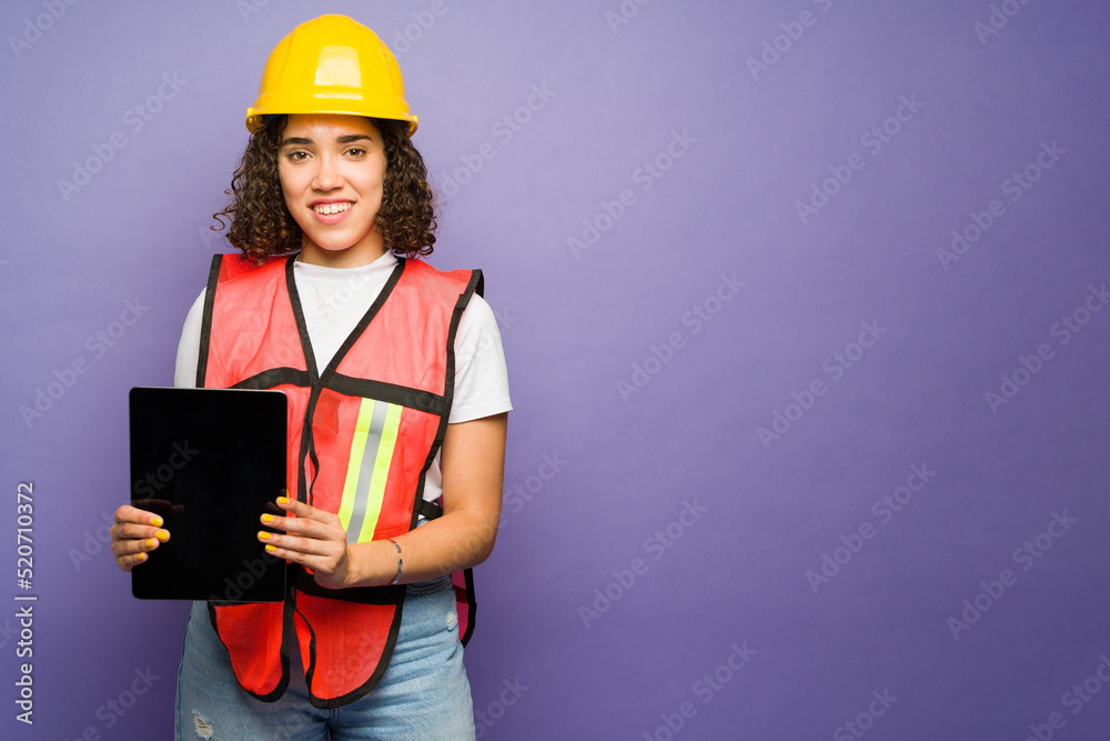 Smiling forewoman holding a tablet while working Smiling forewoman holding a tablet while working