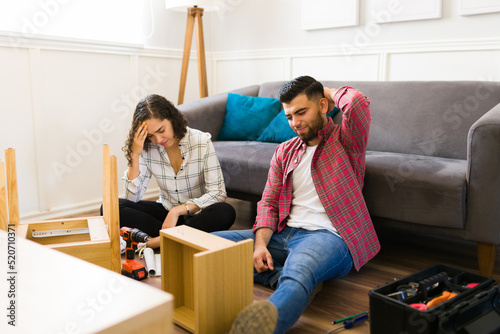 Frustrated couple having problems while assembling furniture