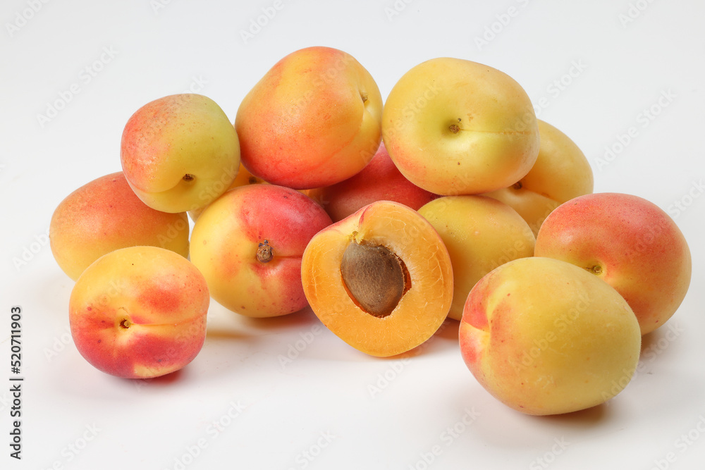 Fresh ripe juicy yellow orange red apricot fruit pile whole cut half slice seed on white background Fresh ripe juicy yellow orange red apricot fruit pile whole cut half slice seed on white background