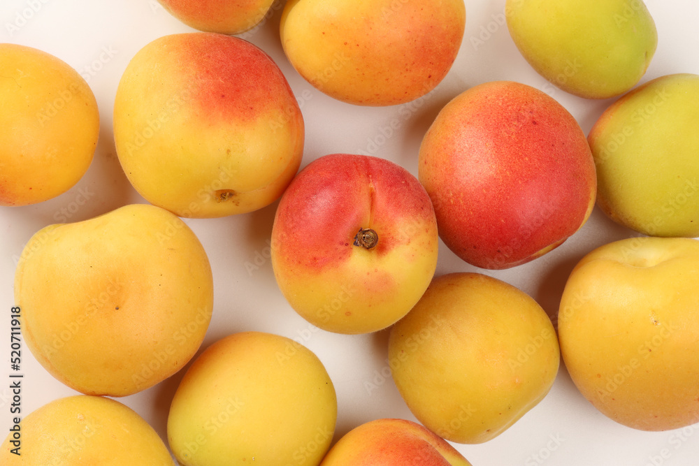 Fresh ripe juicy yellow orange red apricot fruit pile whole cut half slice seed on white background flat lay top view Fresh ripe juicy yellow orange red apricot fruit pile whole cut half slice seed on white background flat lay top view