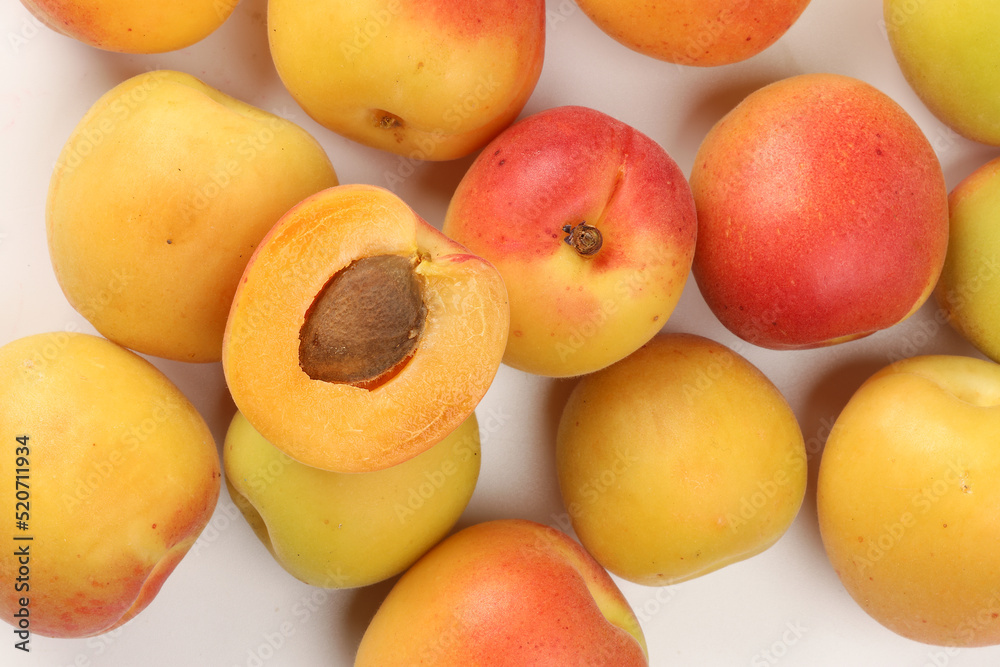 Fresh ripe juicy yellow orange red apricot fruit pile whole cut half slice seed on white background flat lay top view Fresh ripe juicy yellow orange red apricot fruit pile whole cut half slice seed on white background flat lay top view
