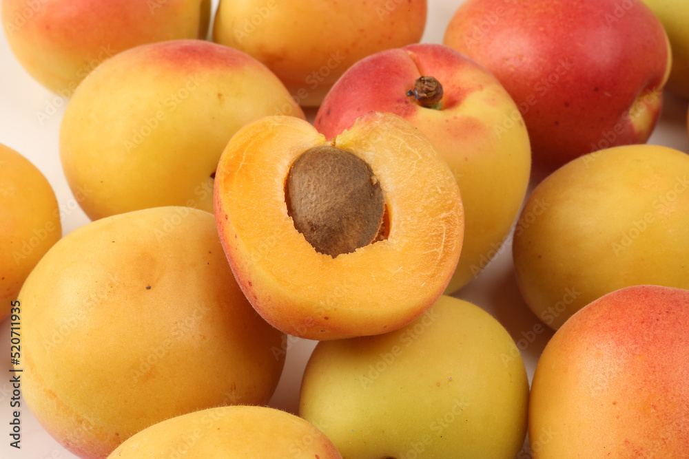 Fresh ripe juicy yellow orange red apricot fruit pile whole cut half slice seed on white background flat lay top view