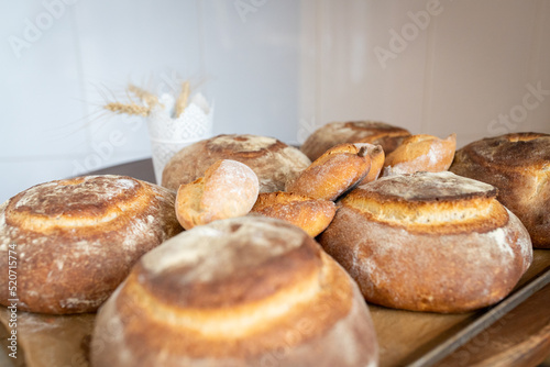 Artisan bread only from the oven on the table in a small home bakery. Front view.