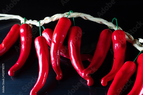 Fototapeta Red chilli peppers on black background