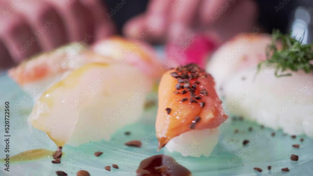 Traditional japanese nigiri sushi with salmon on plate. Nigiri sushi rotating on a board Traditional japanese nigiri sushi with salmon on plate. Nigiri sushi rotating on a board