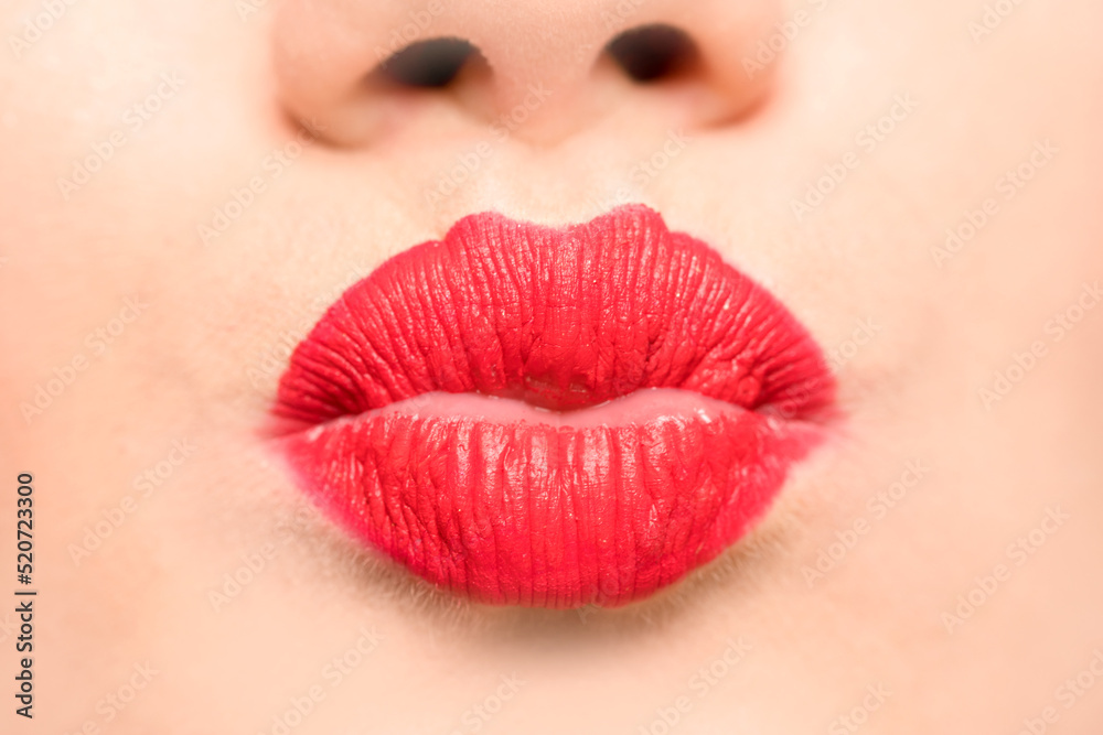 Female lips with red lipstick and a kiss gesture. Female lips with red lipstick and a kiss gesture.