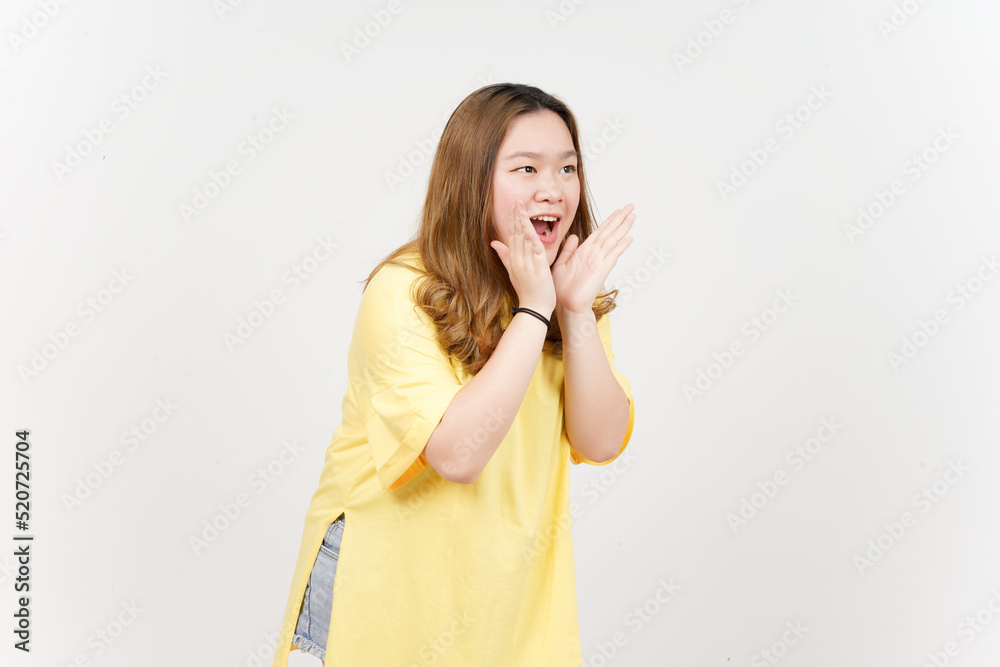 Announcement with hands over mouth of Beautiful Asian Woman wearing yellow T-Shirt Isolated On White Announcement with hands over mouth of Beautiful Asian Woman wearing yellow T-Shirt Isolated On White