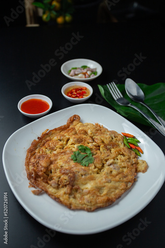 Minced pork omelette in white plate served with tomato sauce, fast food, high protein rental top view.
