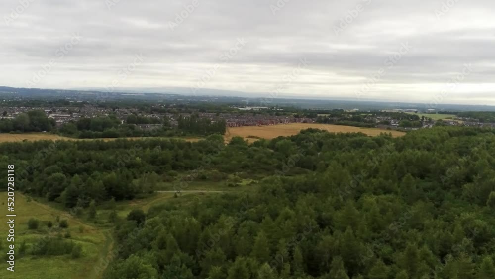 Aerial view panning above British woodland forest trees in scenic rural countryside park wilderness Aerial view panning above British woodland forest trees in scenic rural countryside park wilderness