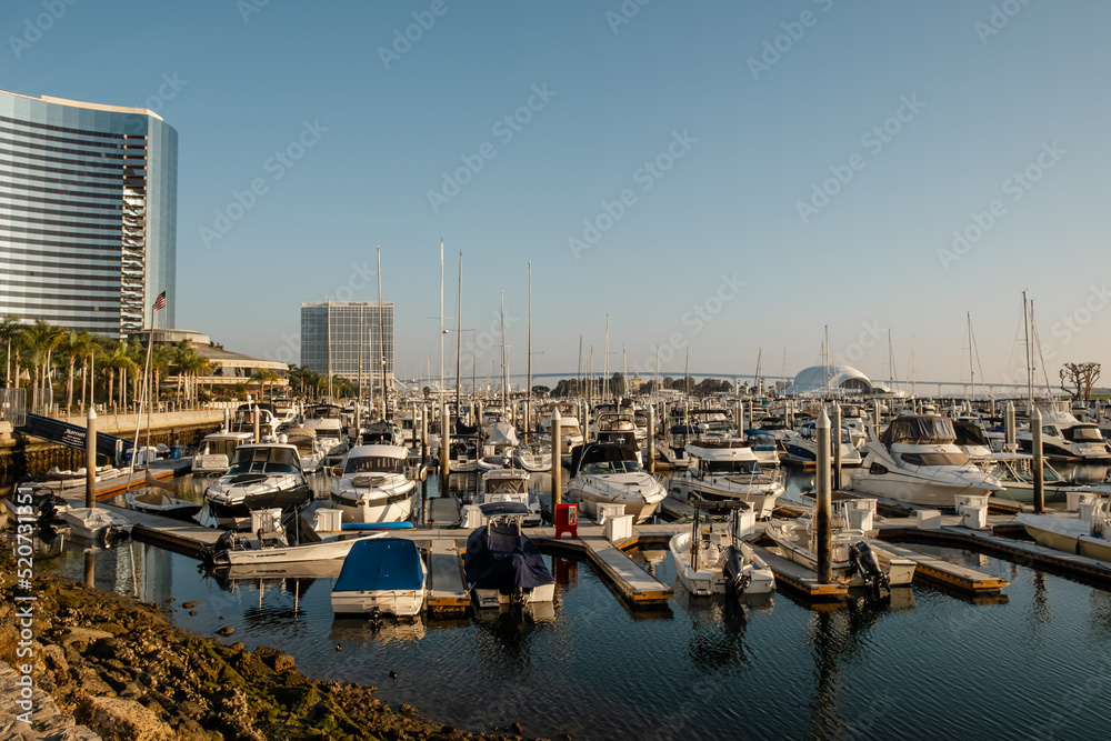 Sailboats at commercial dock. Boats moored in Mission Bay, San Diego. California during cloudy day. Boats docked in a marina, San Diego, California, USA