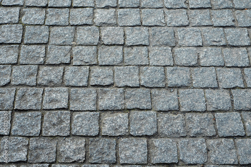 Road or foot path stone surface. Abstract texture for design. Rough stone surface. Traditional construction material