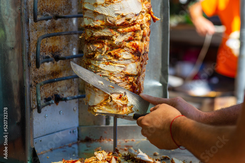Canvas Print Chef cutting with doner knife Traditional Turkish Doner Kebab meat
