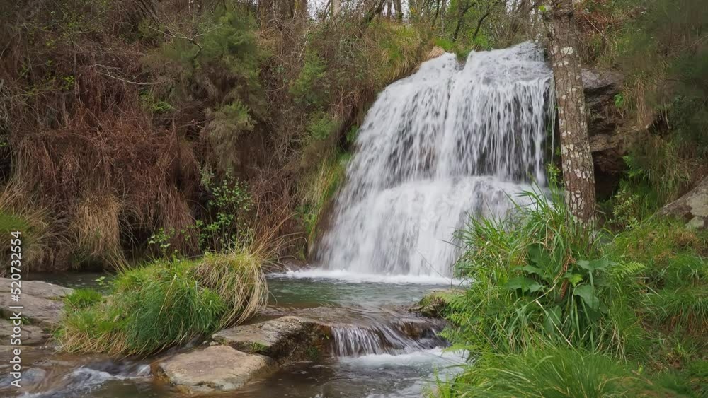 Establisher view of majestic natural waterfall Da Grova in Valença do Minho, day