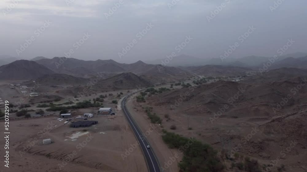 Aerial rising from road between mountains near Al Lith hot spring