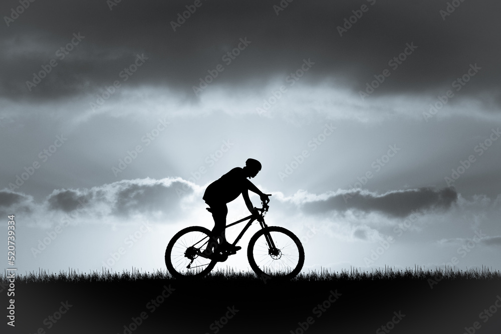 Silhouette of a cyclist in a beautiful evening meadow. bike vacation ideas