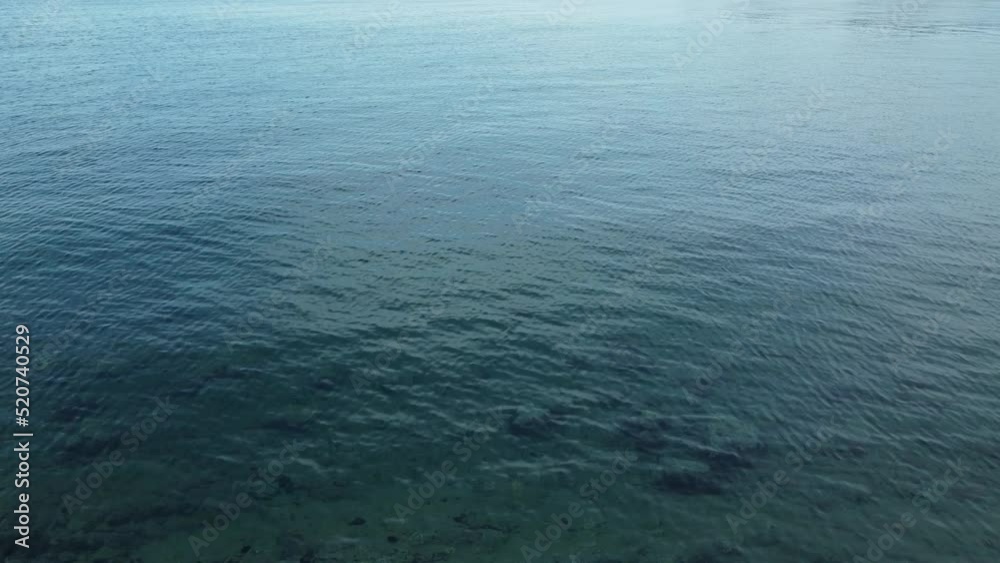 rocky seabed captured through the clear surface of the slightly rippled sea, Adriatic Sea, Croatia, summer, late morning rocky seabed captured through the clear surface of the slightly rippled sea, Adriatic Sea, Croatia, summer, late morning