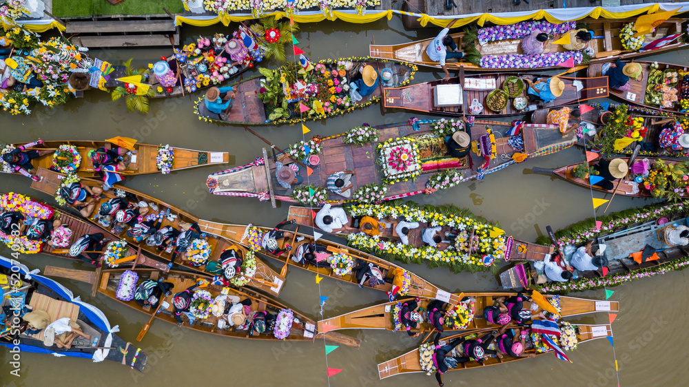 Aerial view floating festival in Thailand, People enjoy the candle procession in the river ceremony, The Buddhist Lent Day in Lad Chado, Ayutthaya, Thailand.