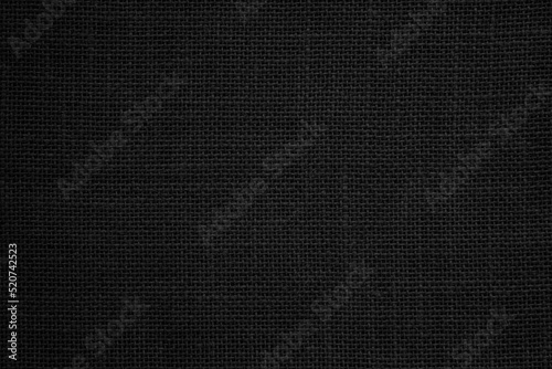 Black hemp rope texture background. Haircloth wale black dark cloth wallpaper. Rustic sackcloth canvas fabric texture in natural.
