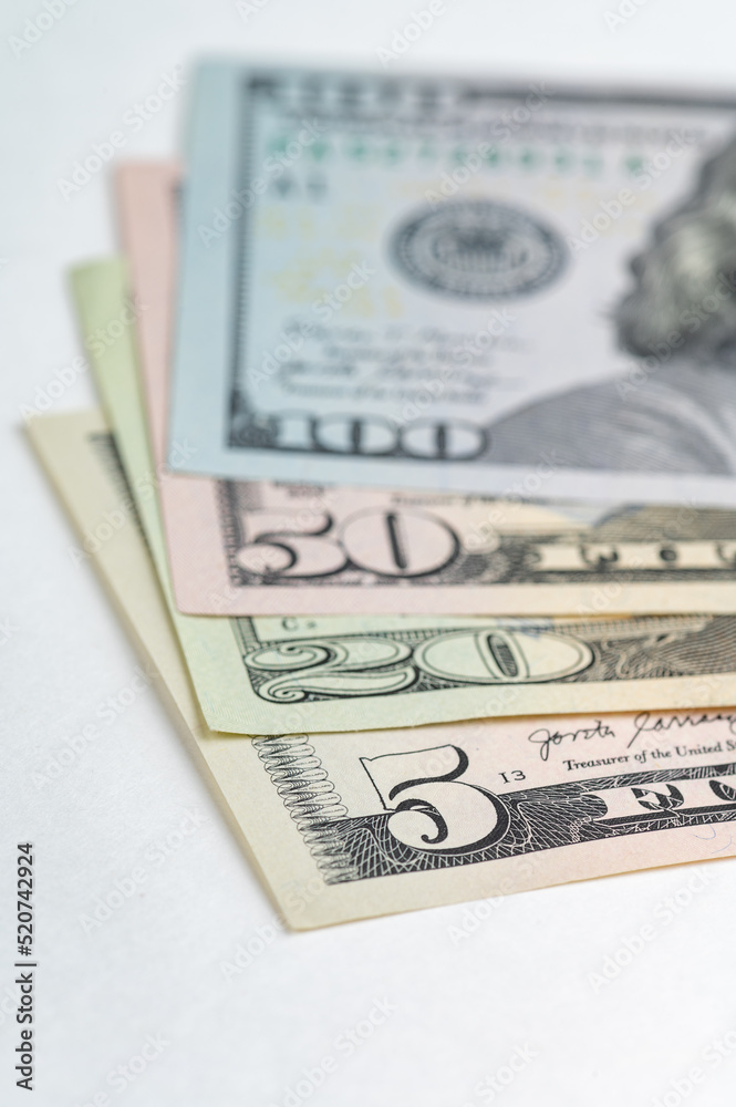 5, 20, 50, 100 dollars banknotes at different angles. Close up of dollars on white background. 5, 20, 50, 100 dollars banknotes at different angles. Close up of dollars on white background.