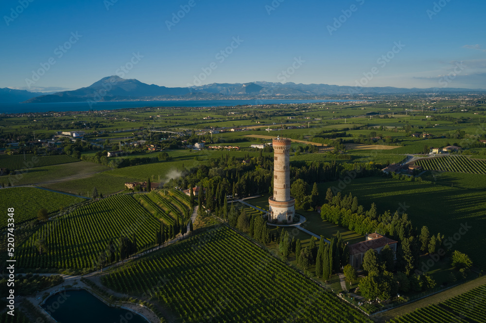 Tower of San Martino della Battaglia, Italy. Sunset.  Tower surrounded by vineyards, blue sky. Aerial view of Lake Garda. Vineyards of Italy on Lake Garda Italy.