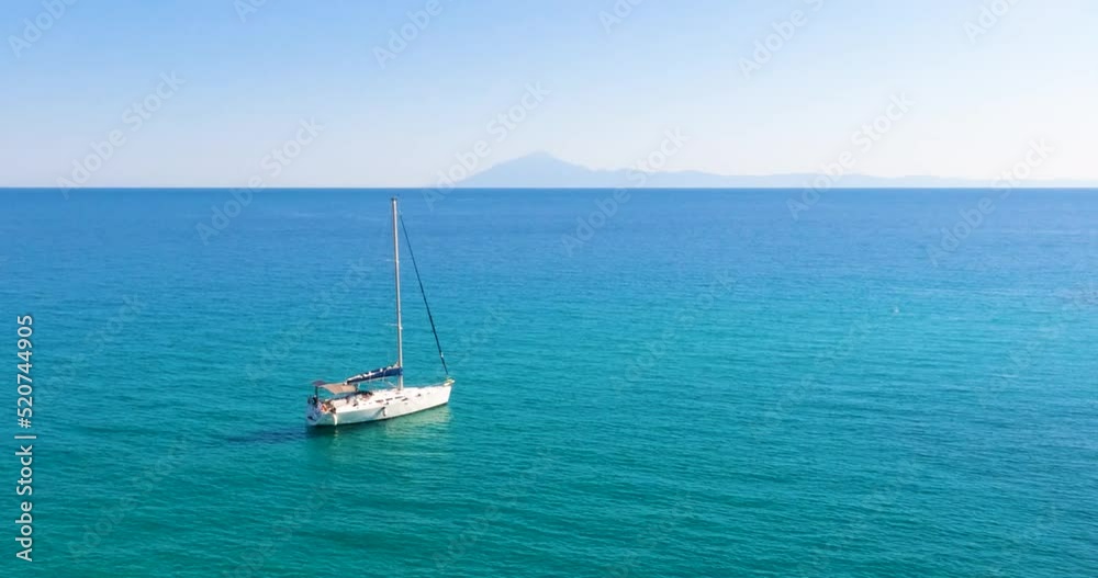 Beautiful seascape with sailing boat on a summer day at bay on the crystal turquoise color sea. Yachting summer travel holiday. Island Thassos, Greece. 4K footage. Beautiful seascape with sailing boat on a summer day at bay on the crystal turquoise color sea. Yachting summer travel holiday. Island Thassos, Greece. 4K footage.