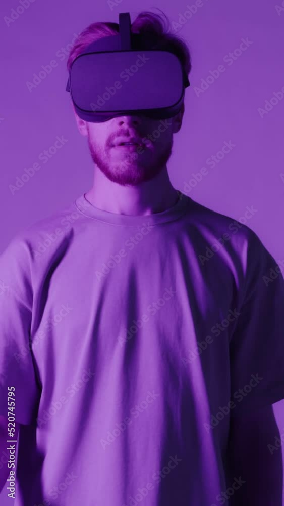 A red-haired guy wearing virtual reality glasses moves his head and hands A red-haired guy wearing virtual reality glasses moves his head and hands