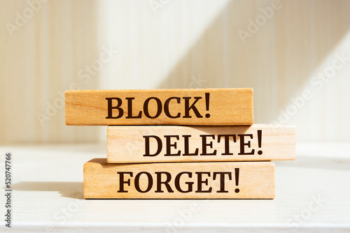 Wooden blocks with words 'BLOCK! DELETE! FORGET!'.