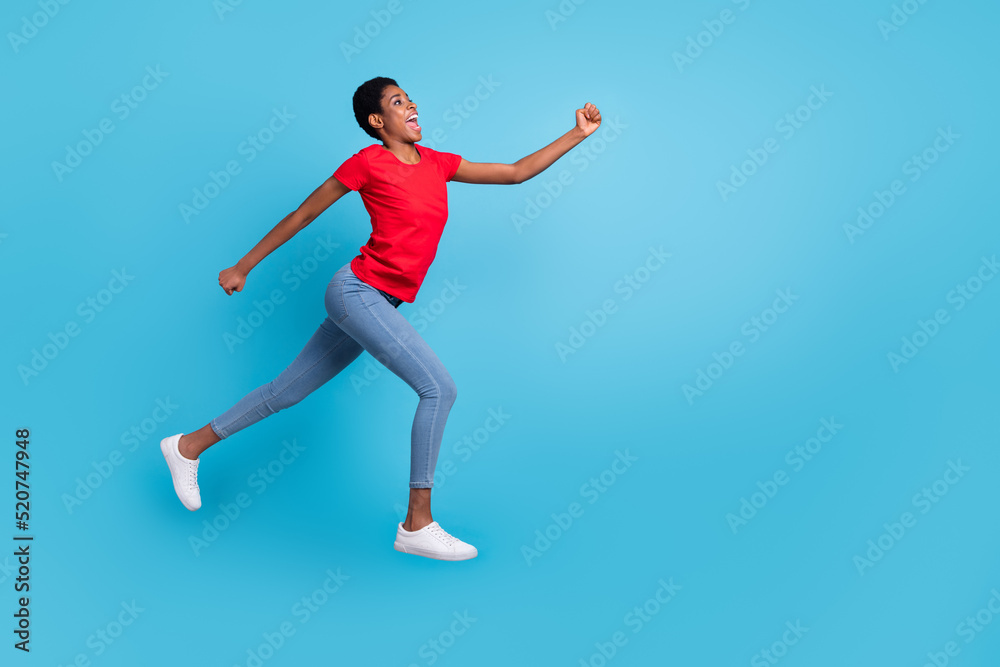 Full size photo of sportive energetic person jump rush look empty space isolated on blue color background