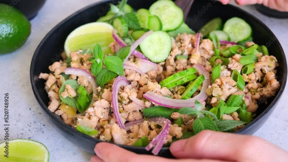 Thai chicken salad larb gai with onion, cucumber and mint. Asian food concept. Thai chicken salad larb gai with onion, cucumber and mint. Asian food concept.