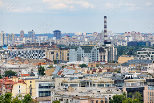 Urban rooftops of old and new residential areas under construction on a summer day.