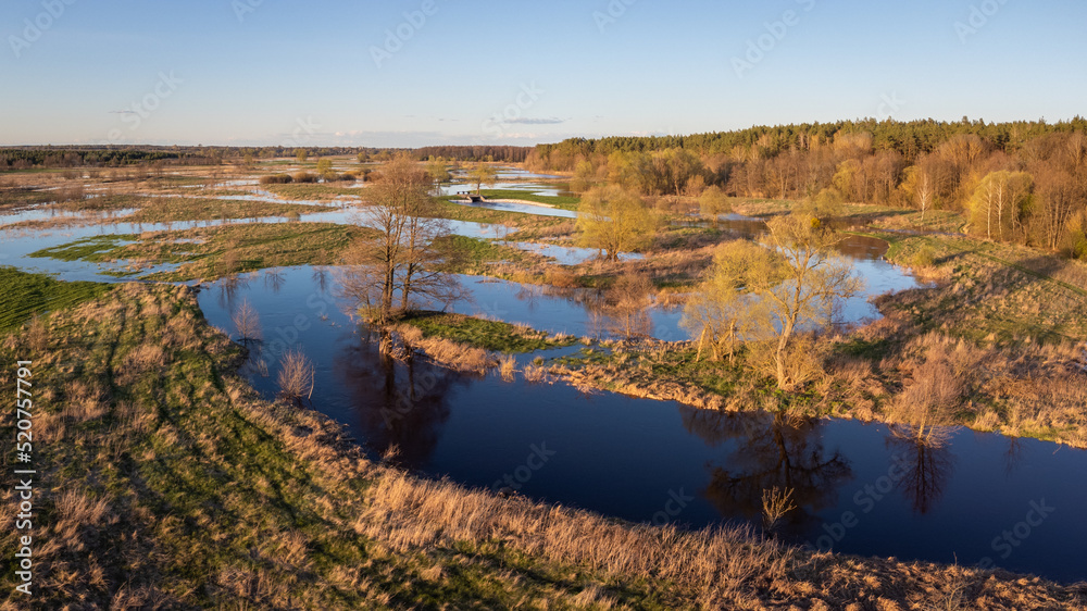 Flooded valley of the river. Evening landscape of river in countryside