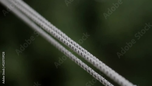 Clotheslines swing slowly in the air closeup. Shallow depth of field