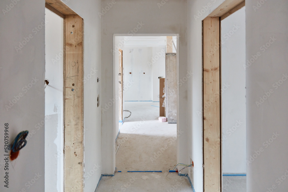 Narrow corridor as a hallway and construction site in a new building Narrow corridor as a hallway and construction site in a new building