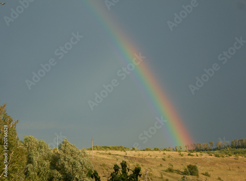 Rainbow over a country after passing storm. High quality photo