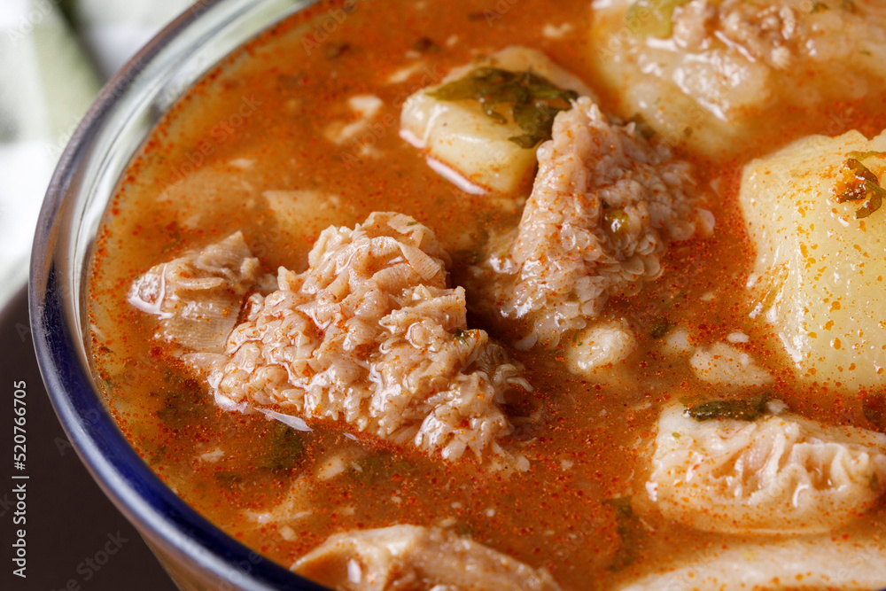 Colombian traditional tripe soup in a glass bowl on wooden table Colombian traditional tripe soup in a glass bowl on wooden table