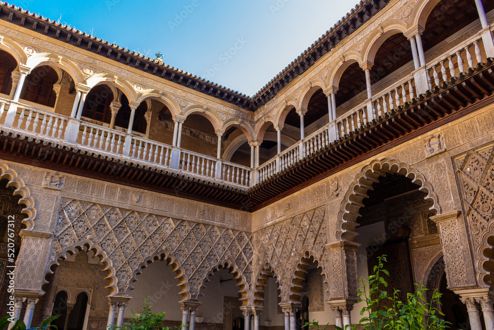 Seville, Spain, September 12, 2021: The Royal Palace of Seville (Real Alcazar). The Maidens Courtyard. The Mudejar of Pedro I on the ground floor and the Renaissance of the first monarchs.