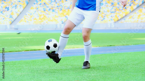 cropped view of football player in shorts bouncing soccer ball with legs © LIGHTFIELD STUDIOS