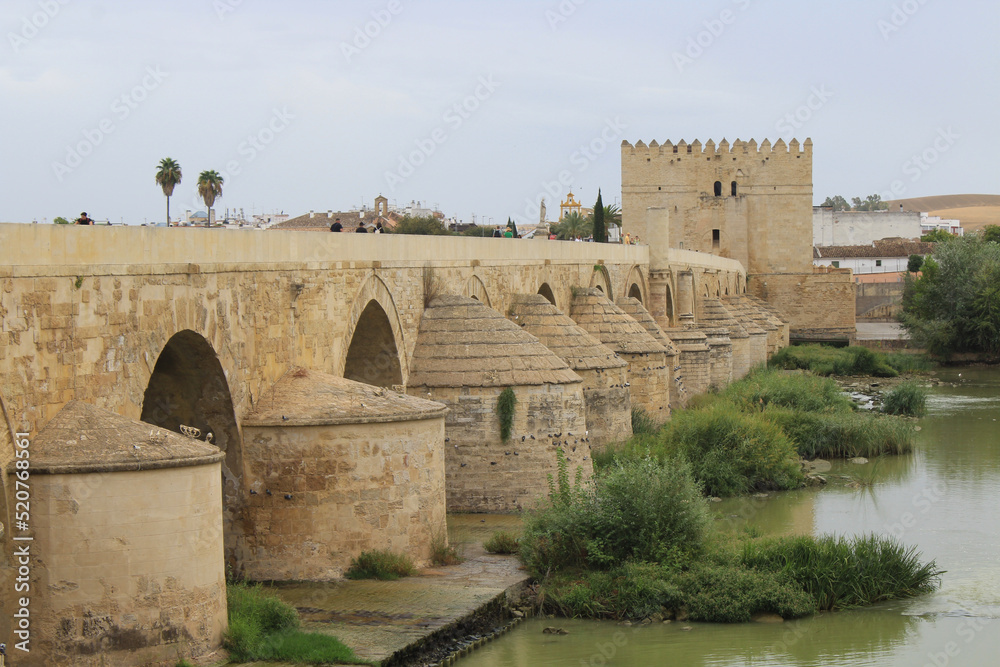 Cordoba, Spain, September 13, 2021: The defensive tower from the Muslim era: the Calahorra Tower, Guadalquivir River, and the Roman Bridge.