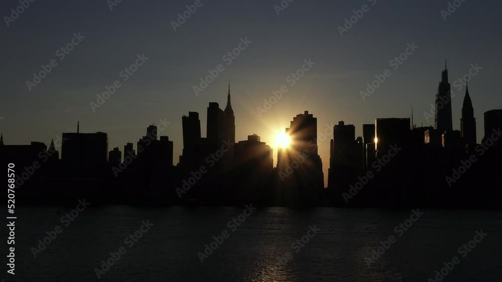 beautiful stationary shot with offset sun through the Midtown Manhattan skyline beautiful stationary shot with offset sun through the Midtown Manhattan skyline