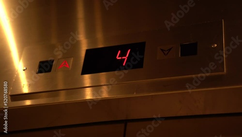 The Elevator going up. Red elevator lights showing floor numbers going up to the top. photo