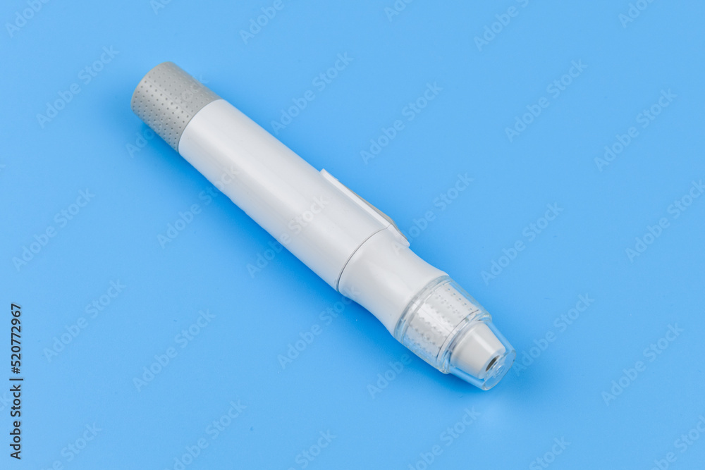 Glucometer isolated on a blue background. Medical device for measuring sugar Glucometer isolated on a blue background. Medical device for measuring sugar