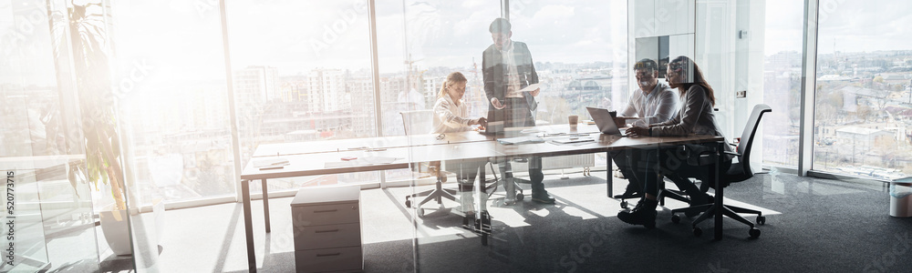 Creative business people working on project in modern office with panoramic view. Blurred background - obrazy, fototapety, plakaty 