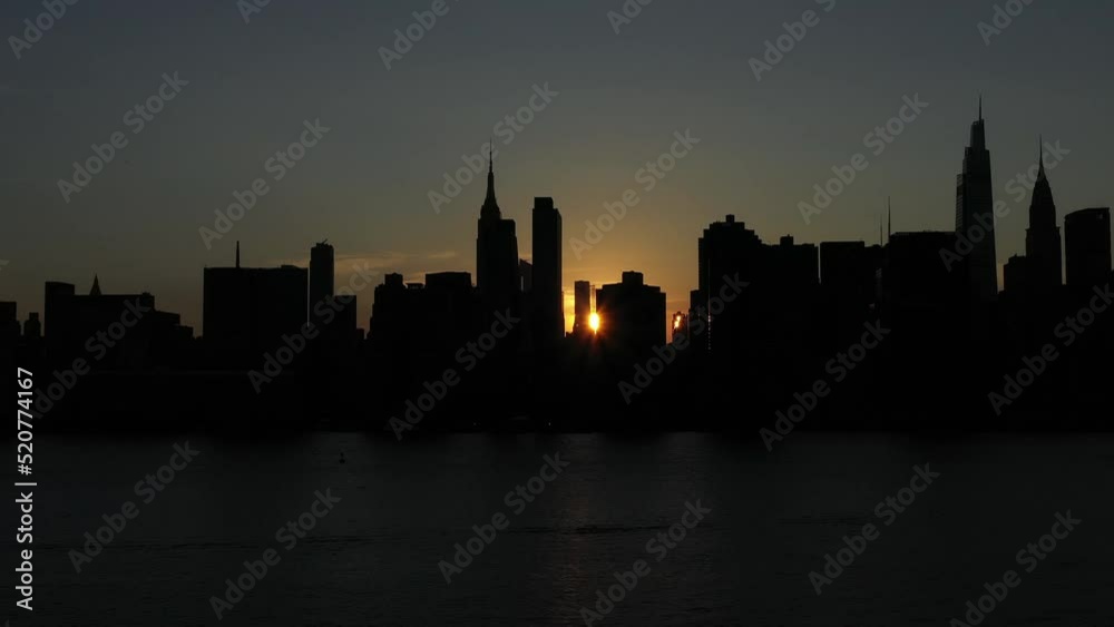 fast rotating trucking shot with parallax of a silhouetted legendary Midtown Manhattan skyline right at sunset fast rotating trucking shot with parallax of a silhouetted legendary Midtown Manhattan skyline right at sunset