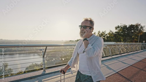 Wallpaper Mural Pensioner calls to friend by smartphone walking at sunrise Torontodigital.ca